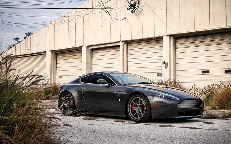 Dark Gray Sports Car — Dramatic, Afternoon, Photograph, Garage Doors, Tall Grass