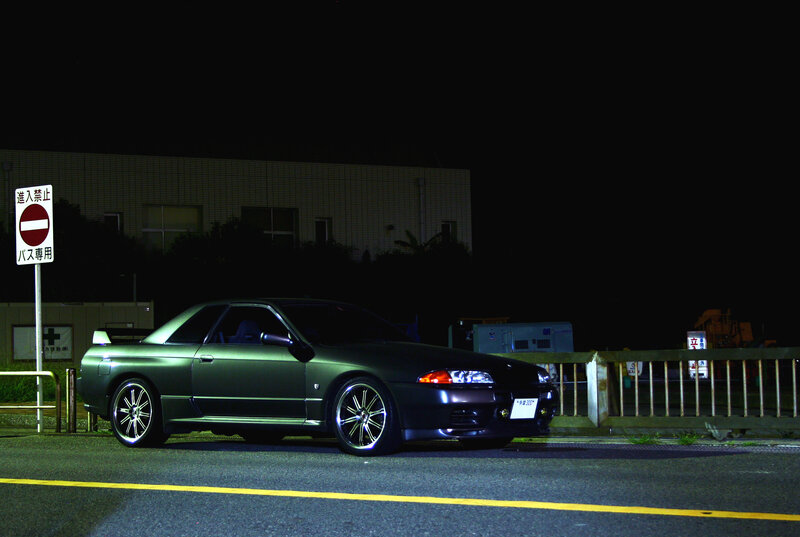 Dark green sports car at night