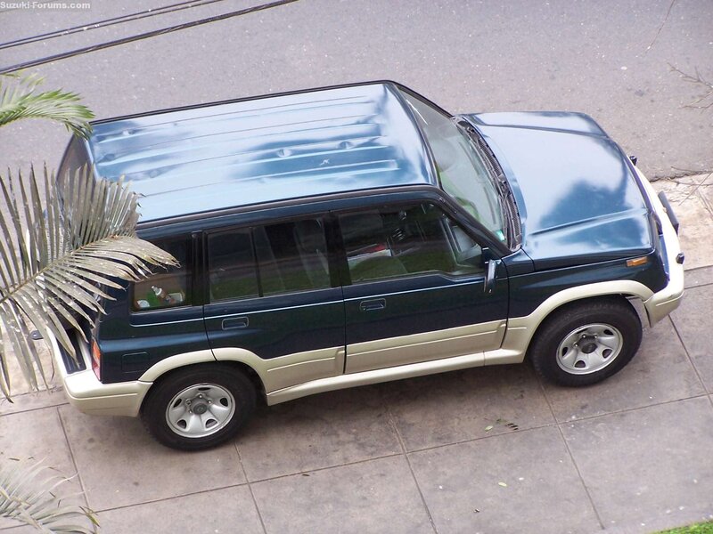 dark green suv on sidewalk