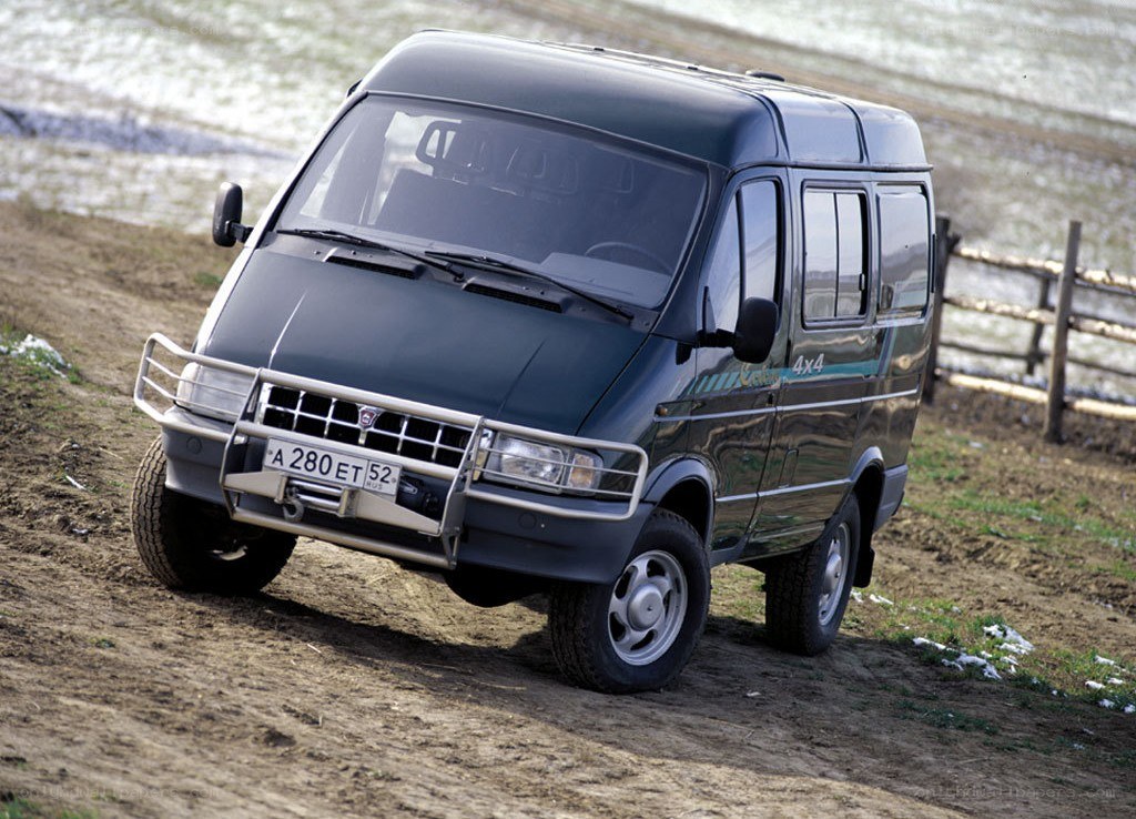 Dark green van on dirt road