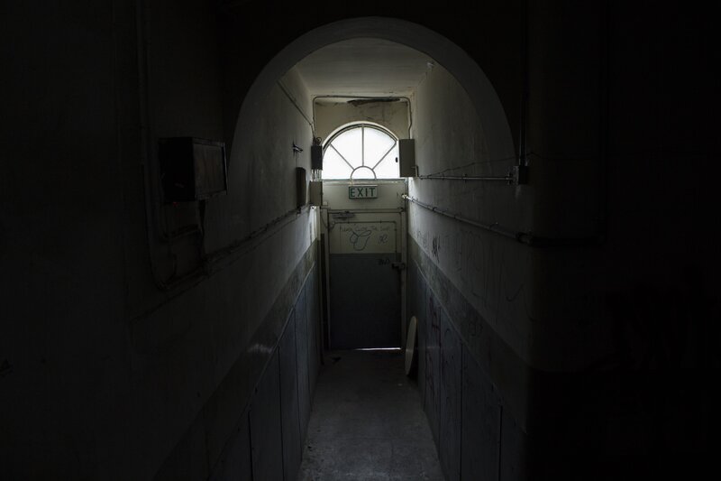 dark hallway with exit door