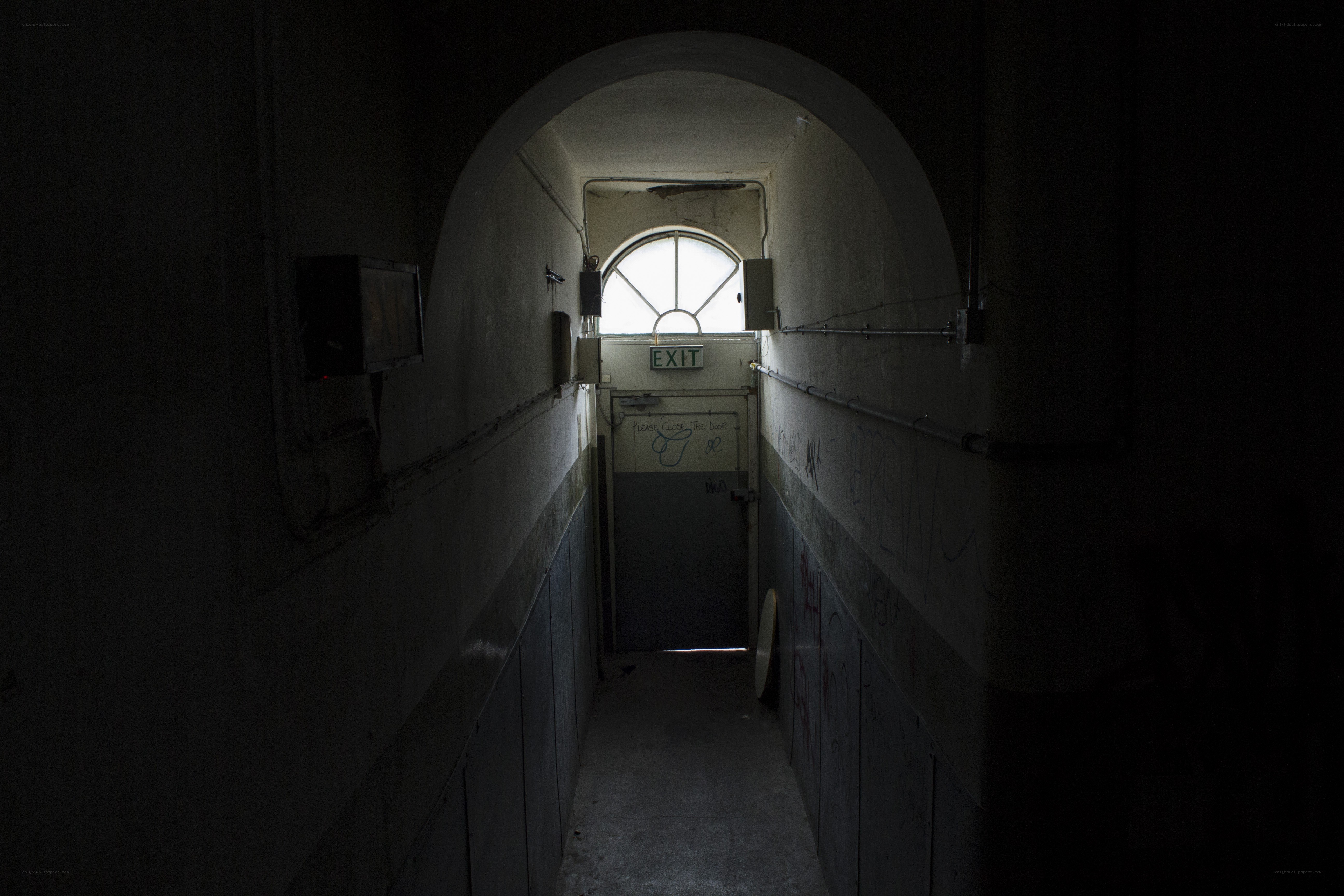 dark hallway with exit door