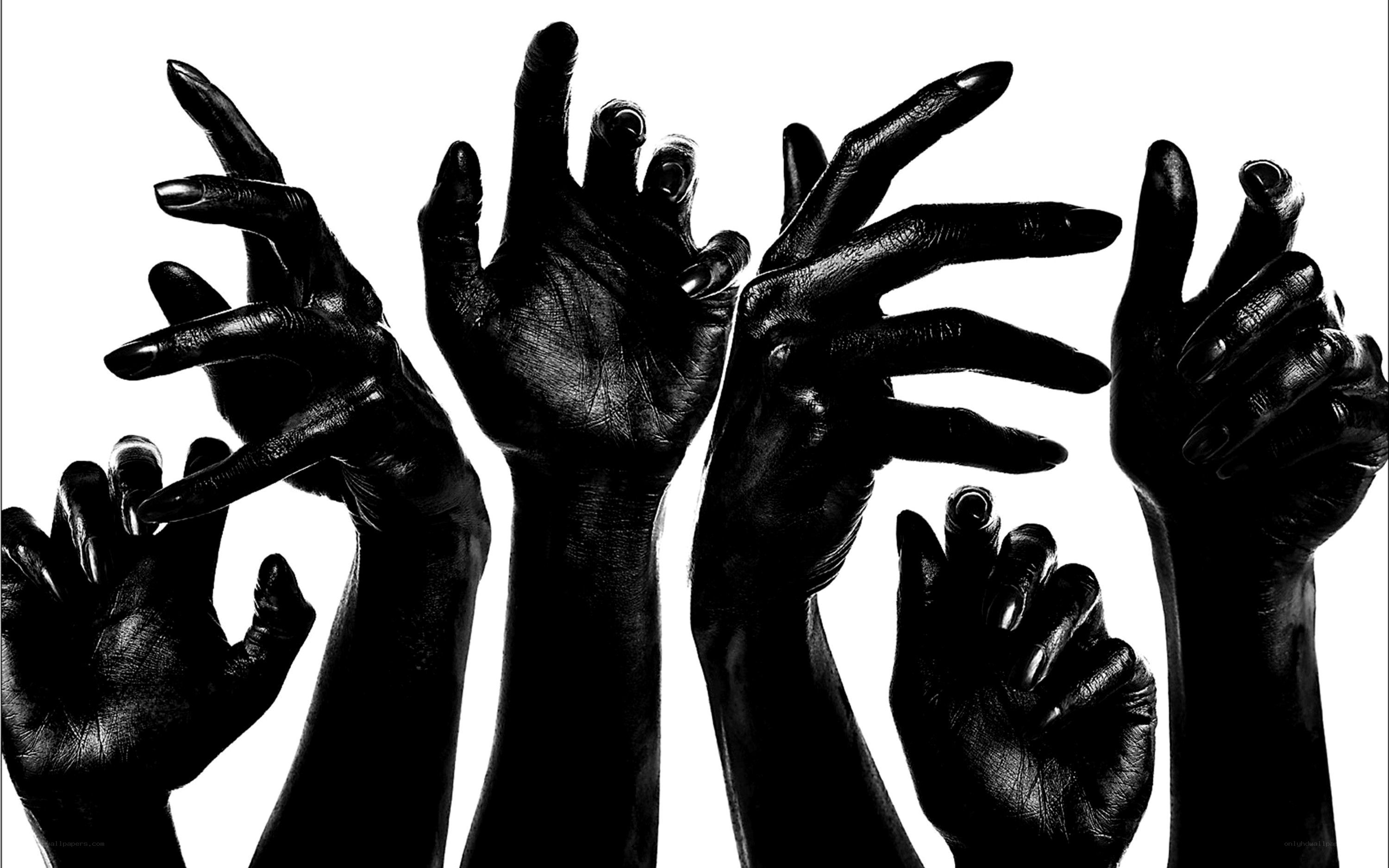 dark hands reaching up