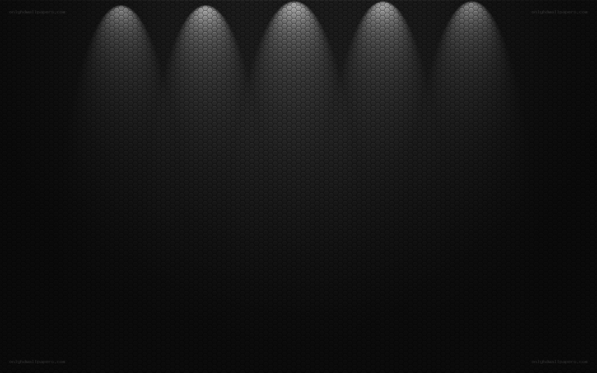 dark hexagonal wall with spotlights