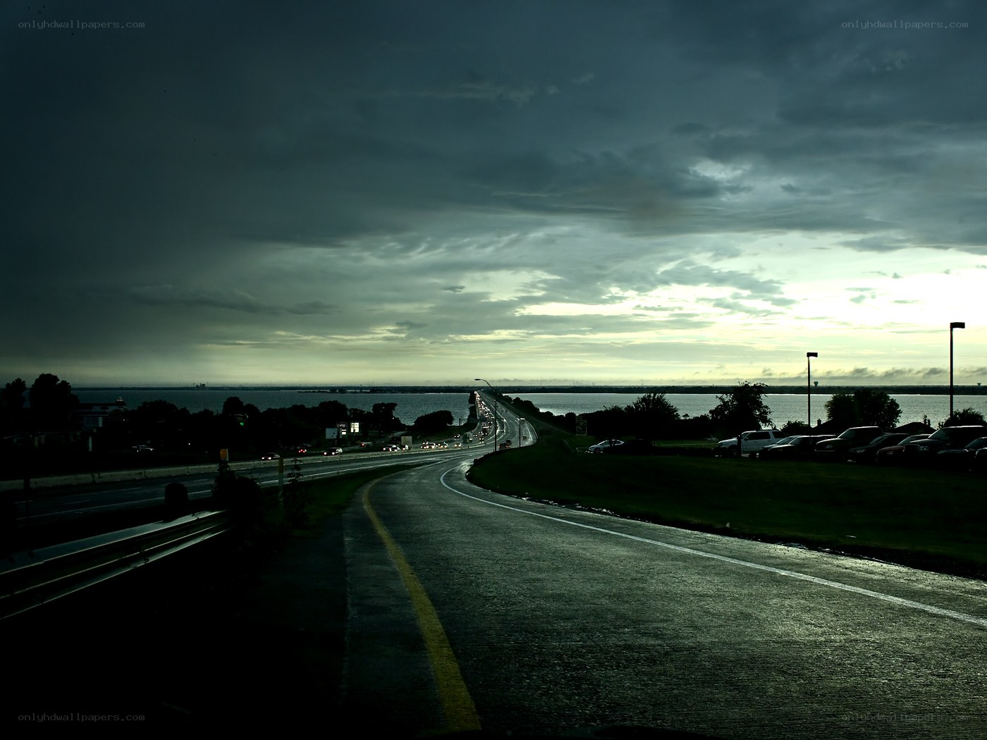 Dark highway over water at dusk