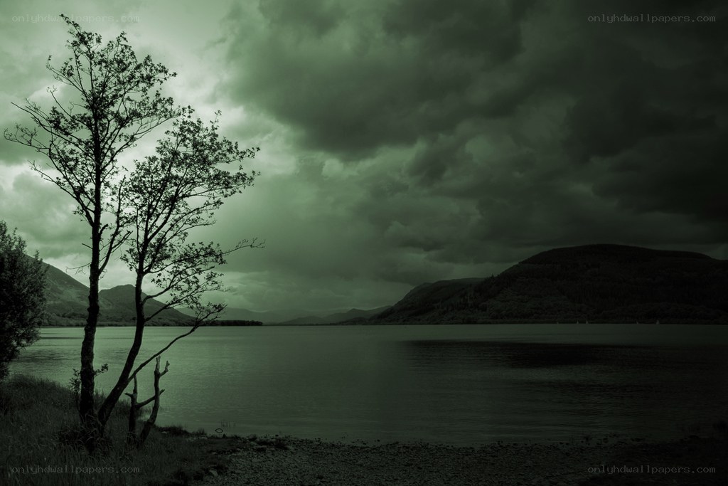 Dark lake under stormy sky