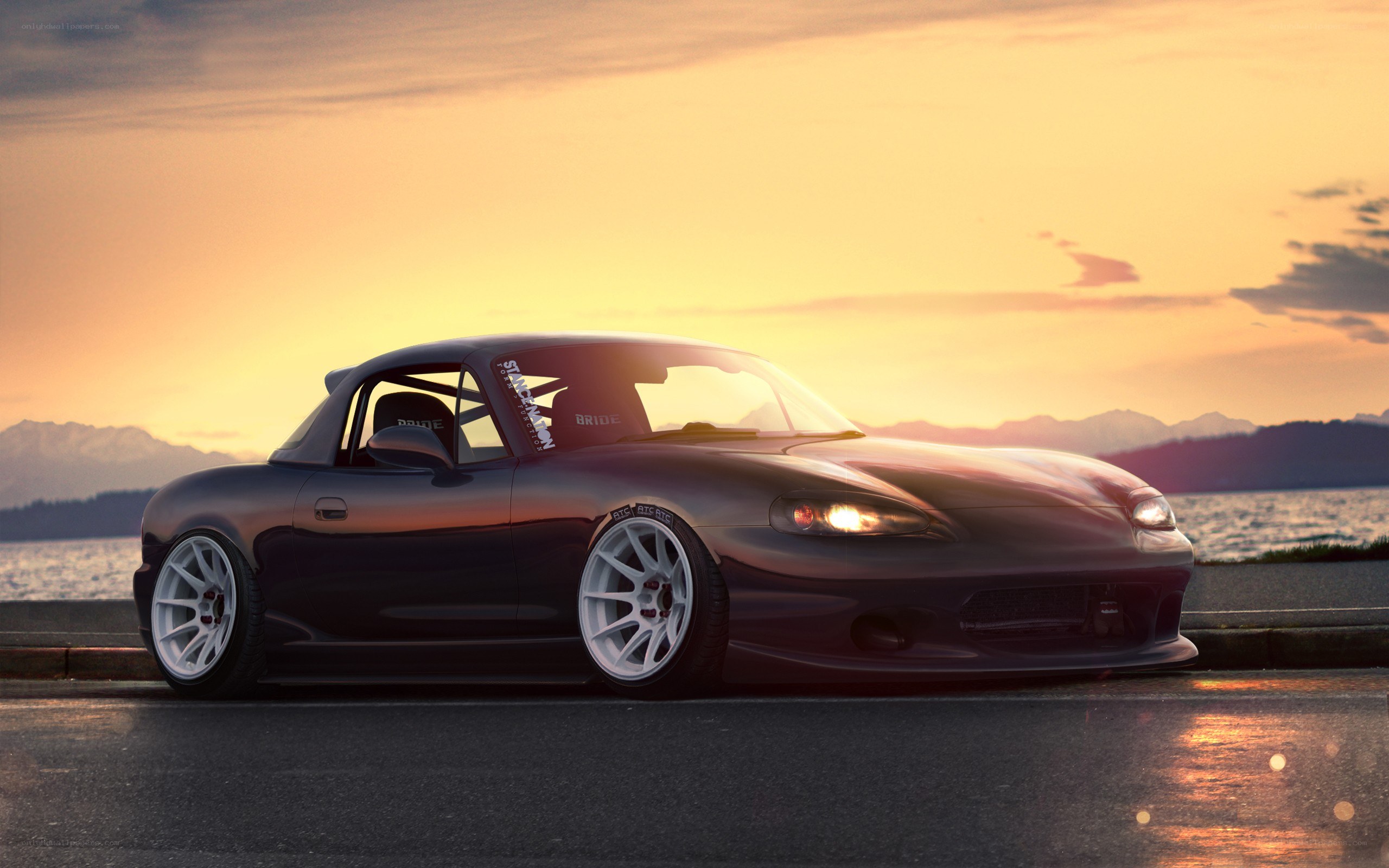 Dark Mazda Miata at sunset