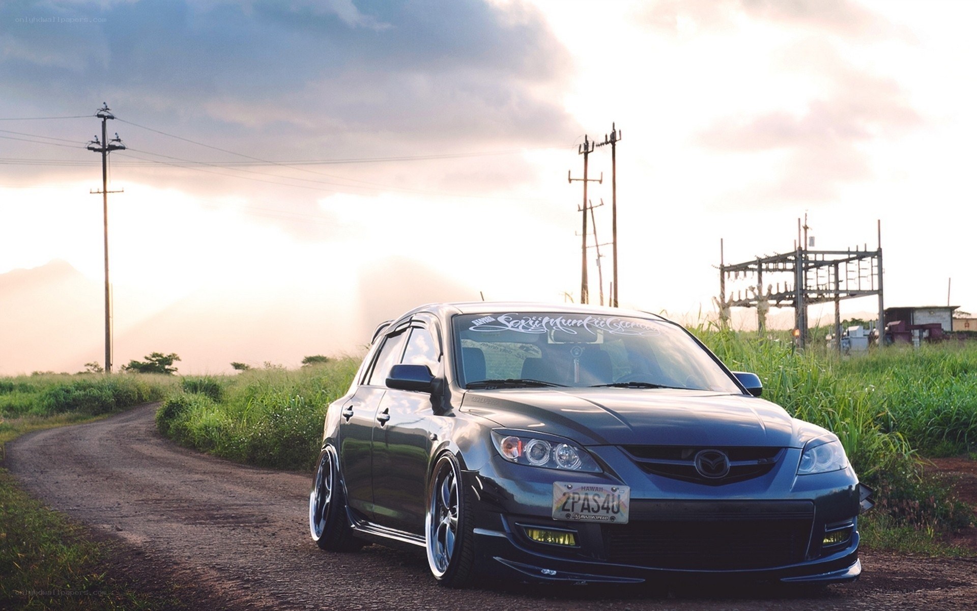 Dark Mazda on a rural road