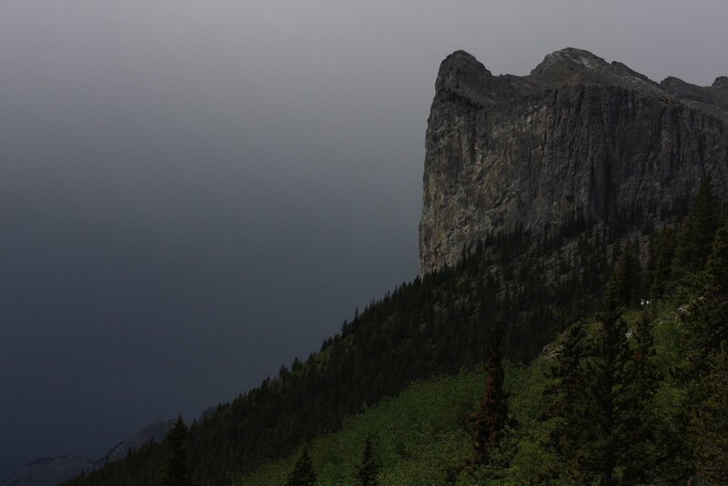 Dark mountain cliff in fog