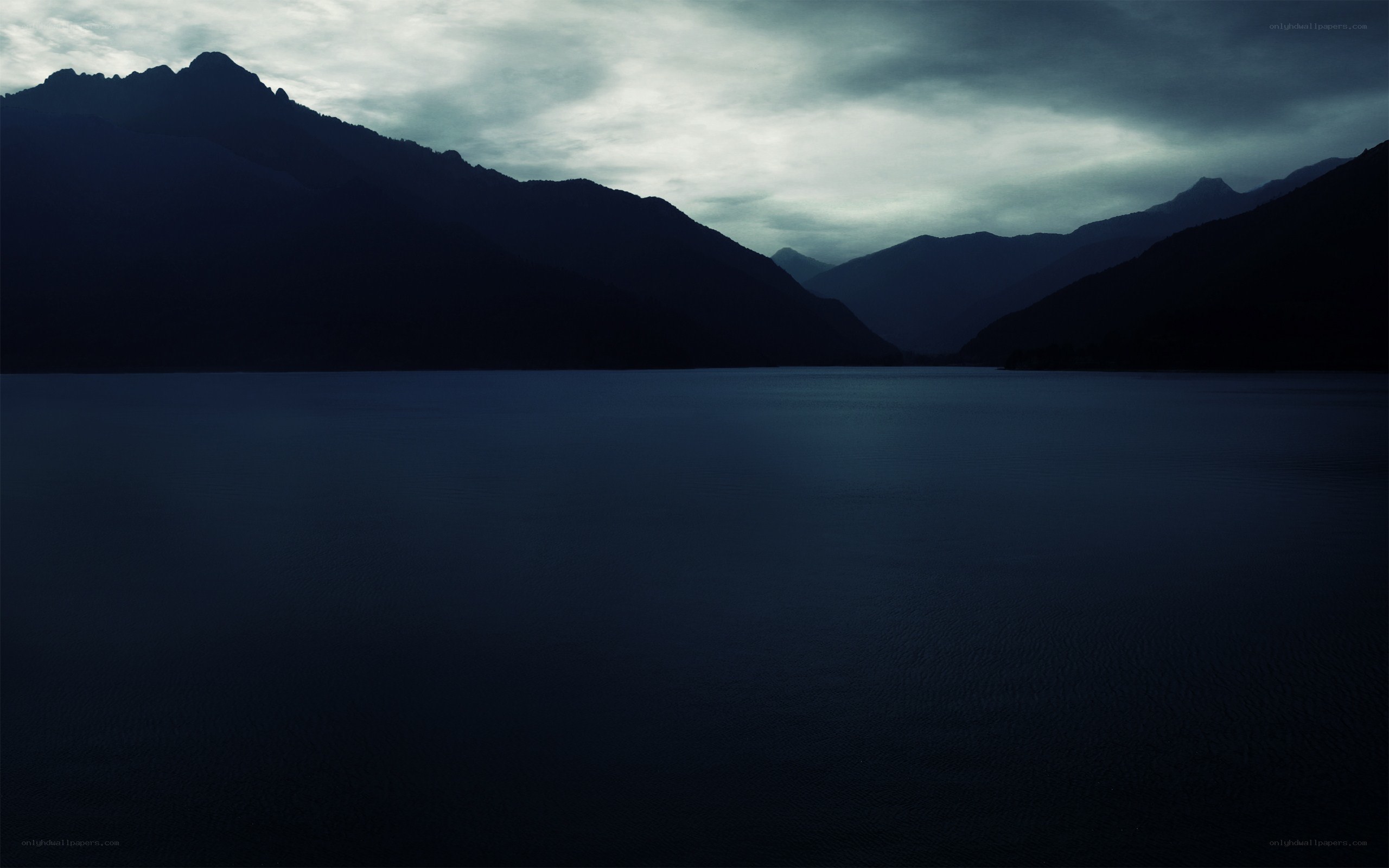 Dark mountain lake at dusk