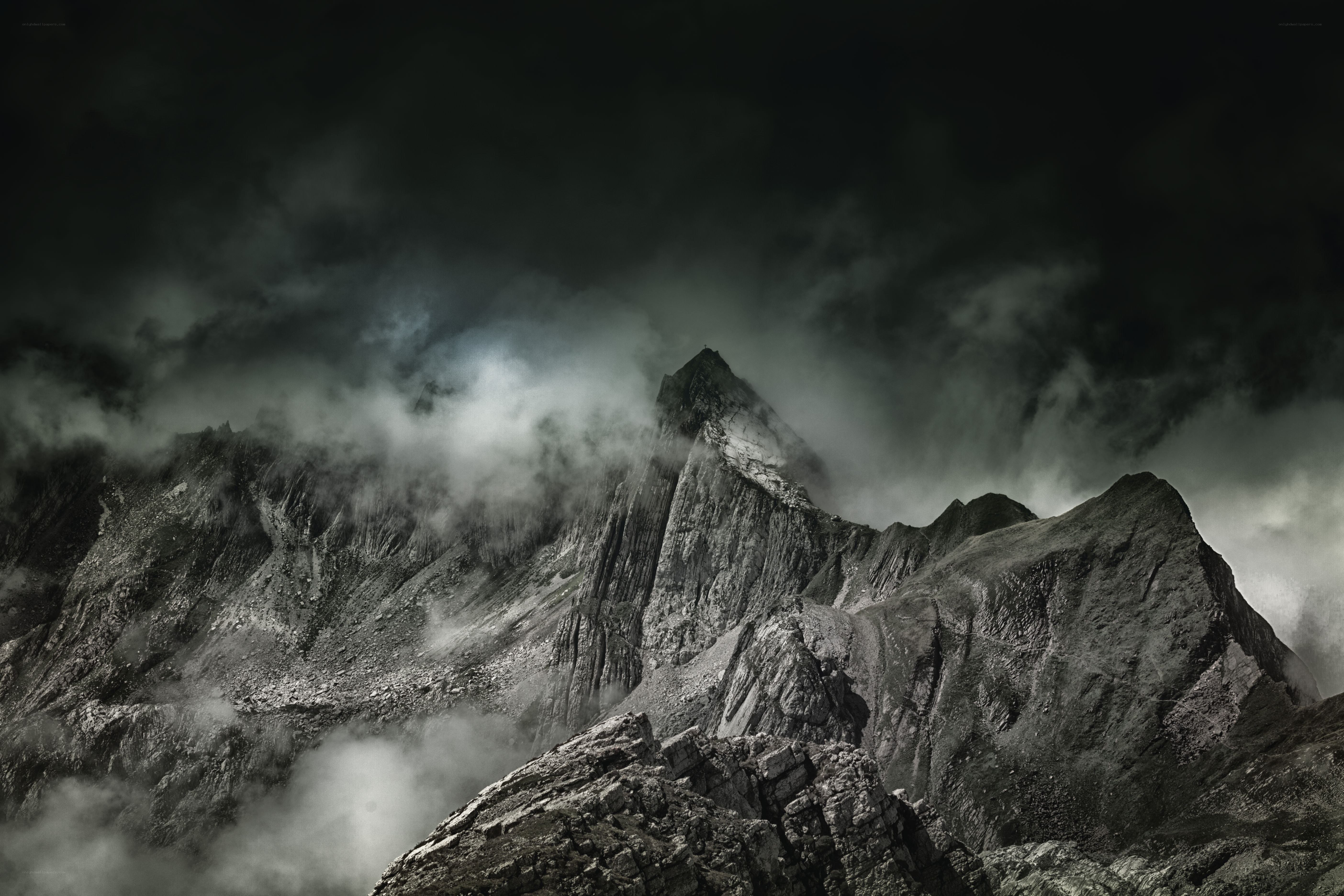 Dark mountain peak shrouded in clouds