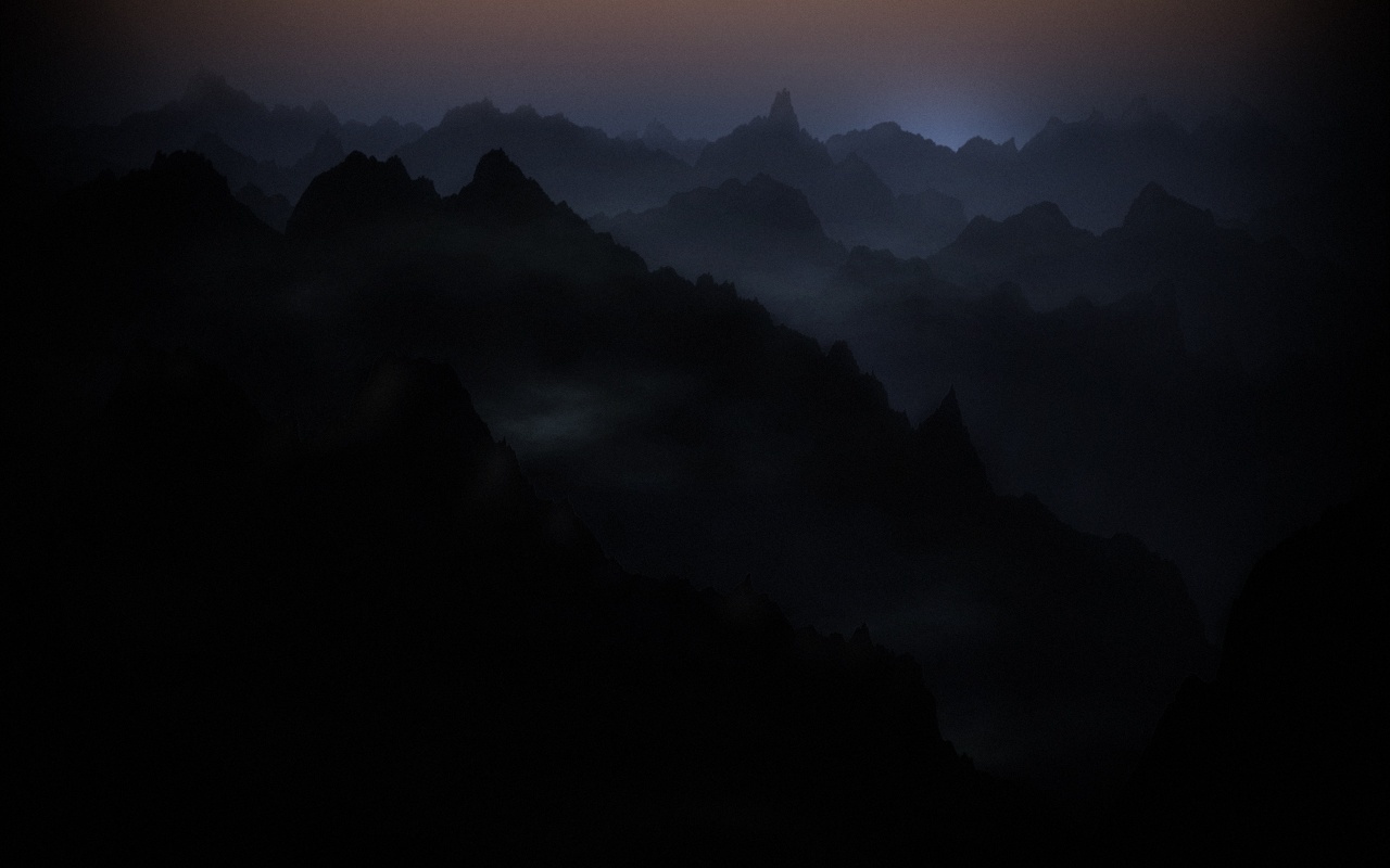 Dark mountain silhouettes at dusk