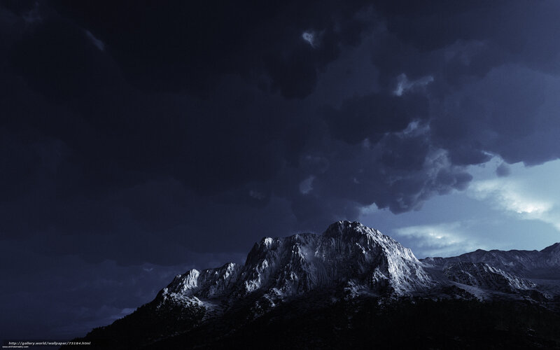 Dark mountain under stormy sky