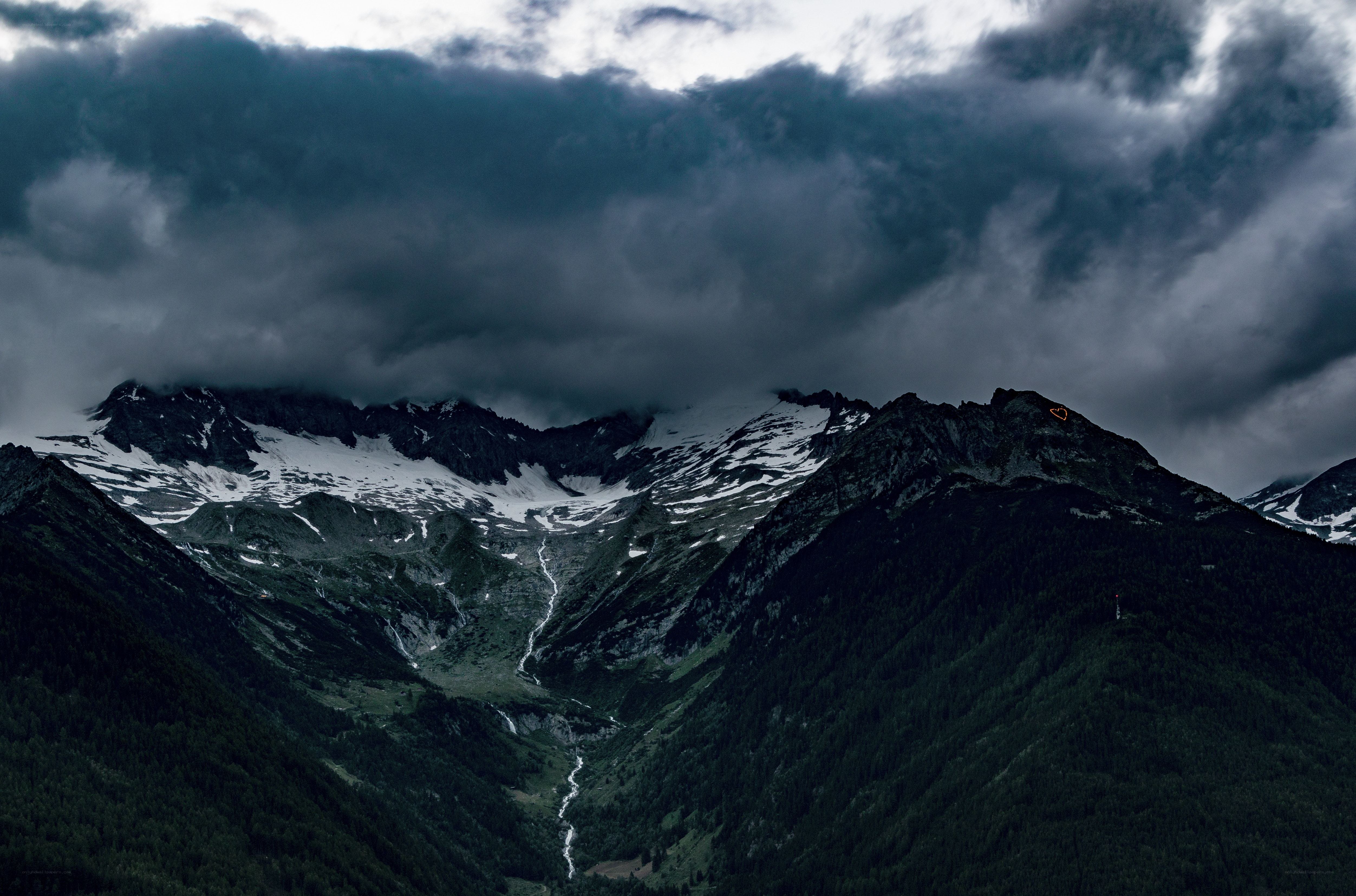 Dark mountains under stormy sky