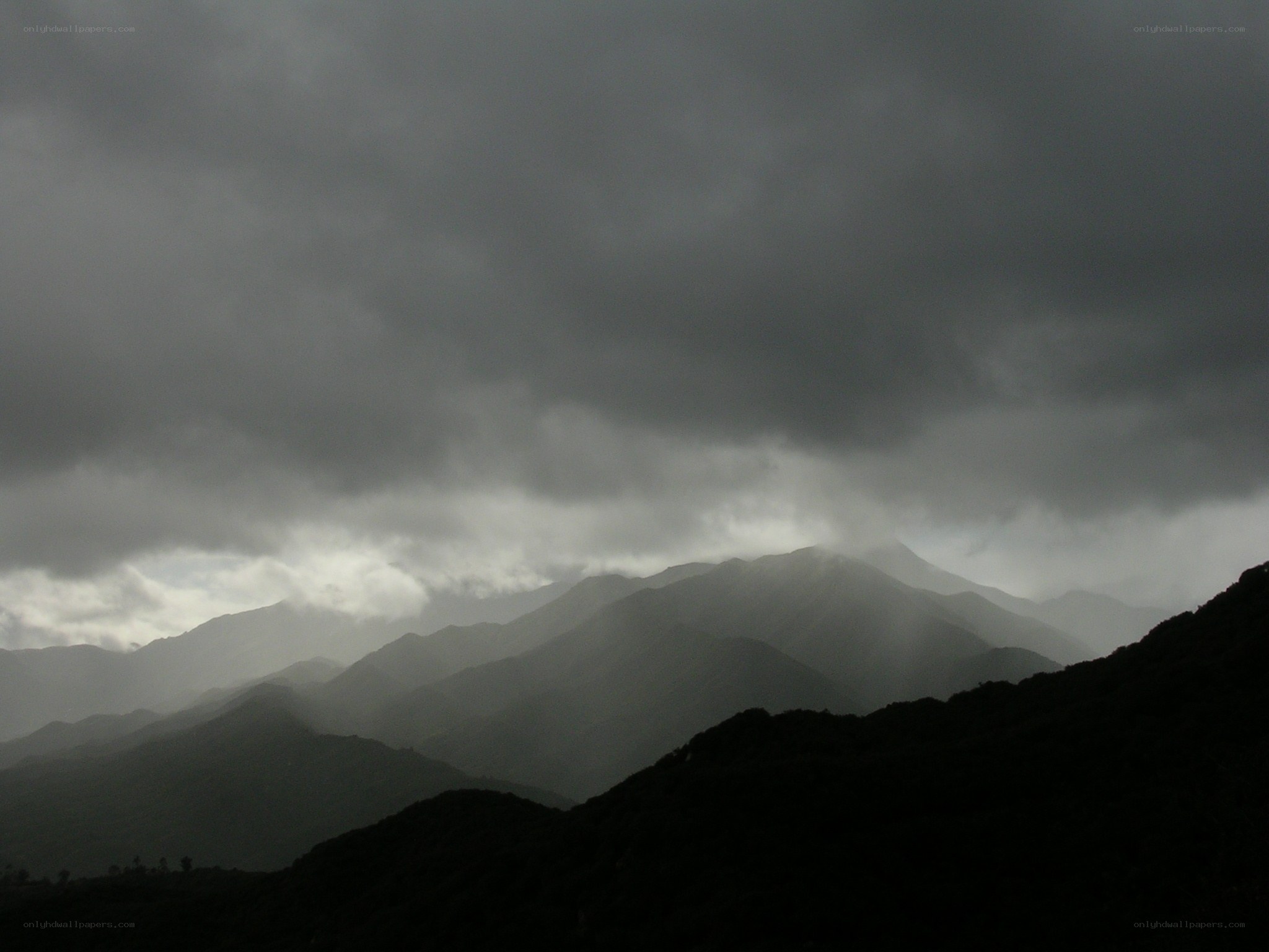 Dark mountains under stormy sky