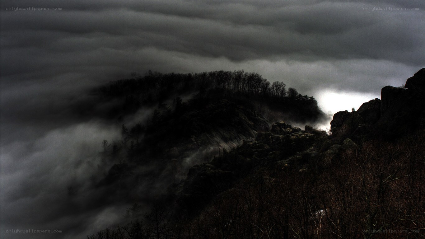 Dark mountains under stormy sky