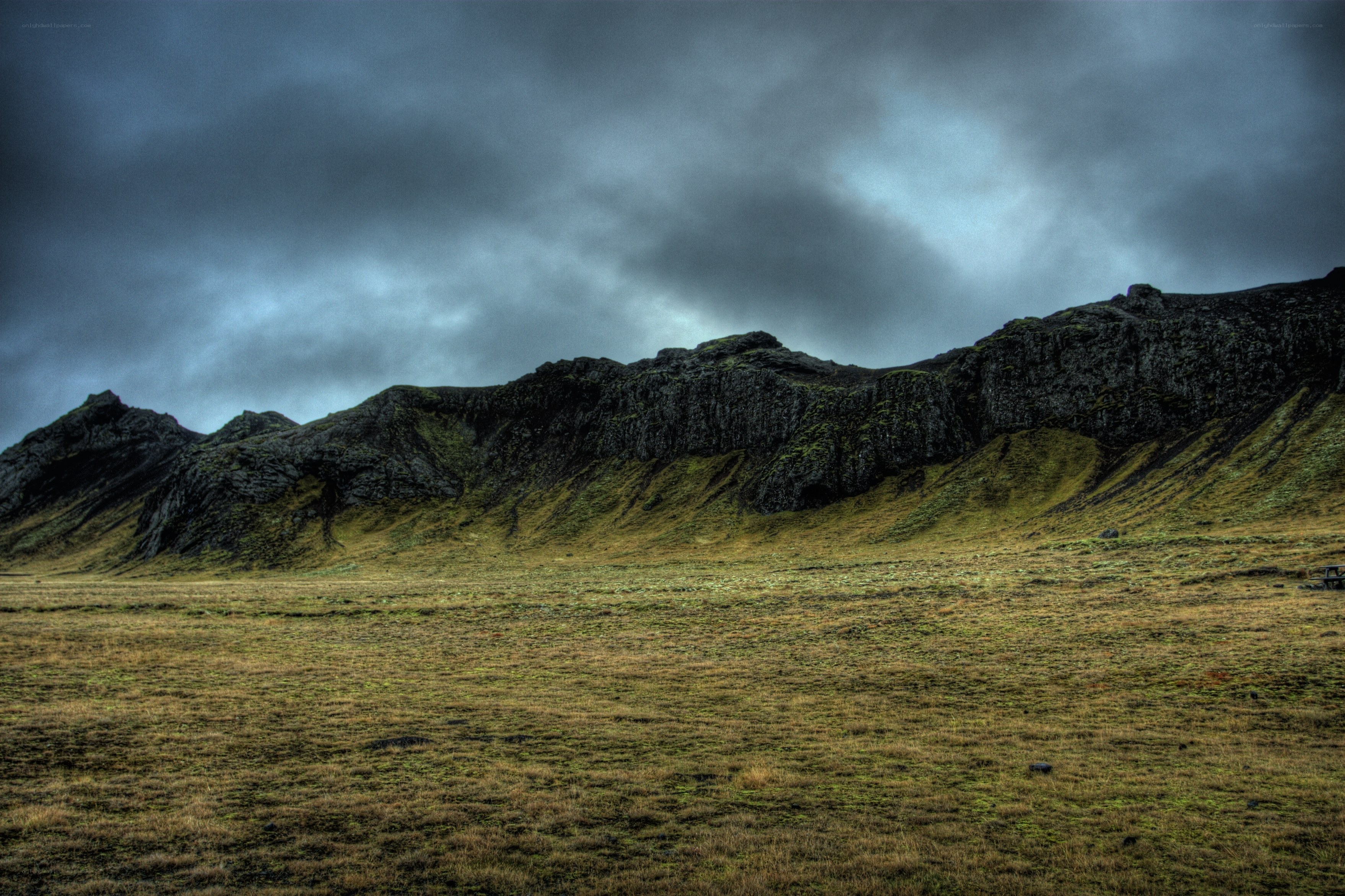 Dark mountains under stormy sky
