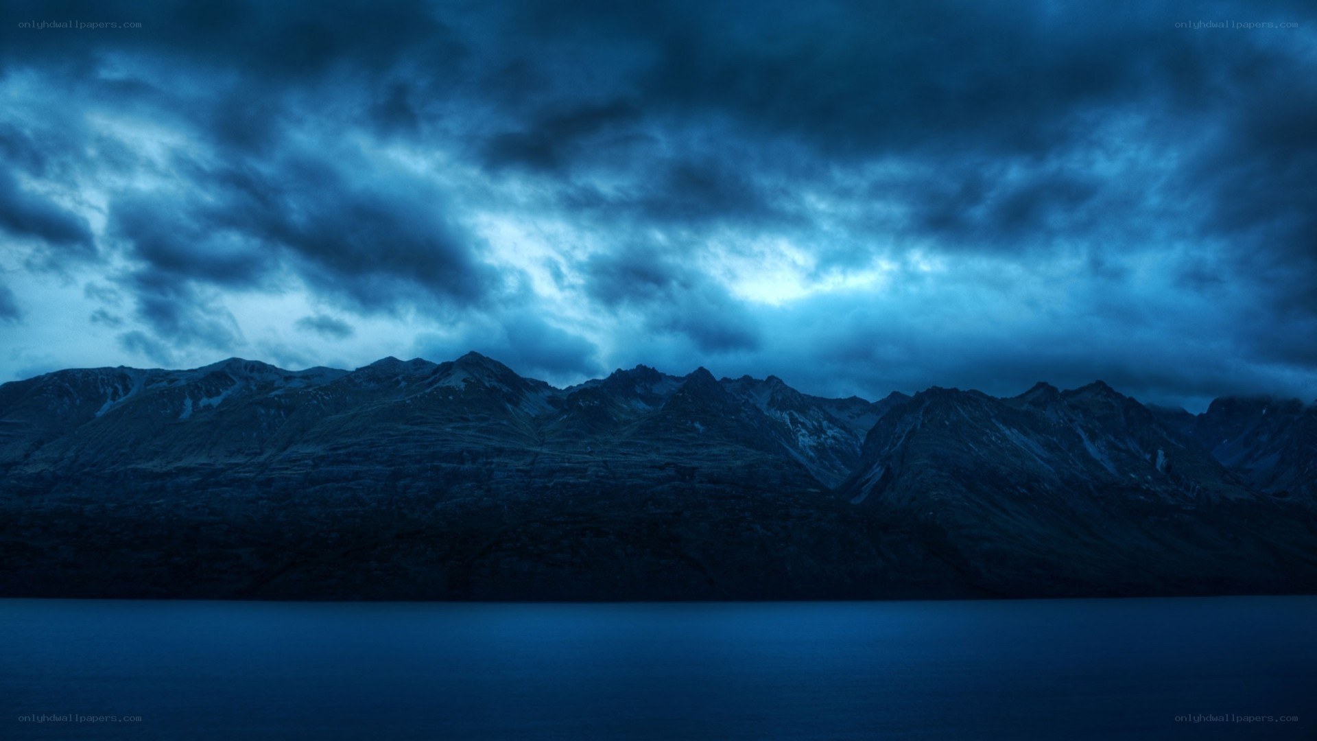 Dark mountains under stormy sky