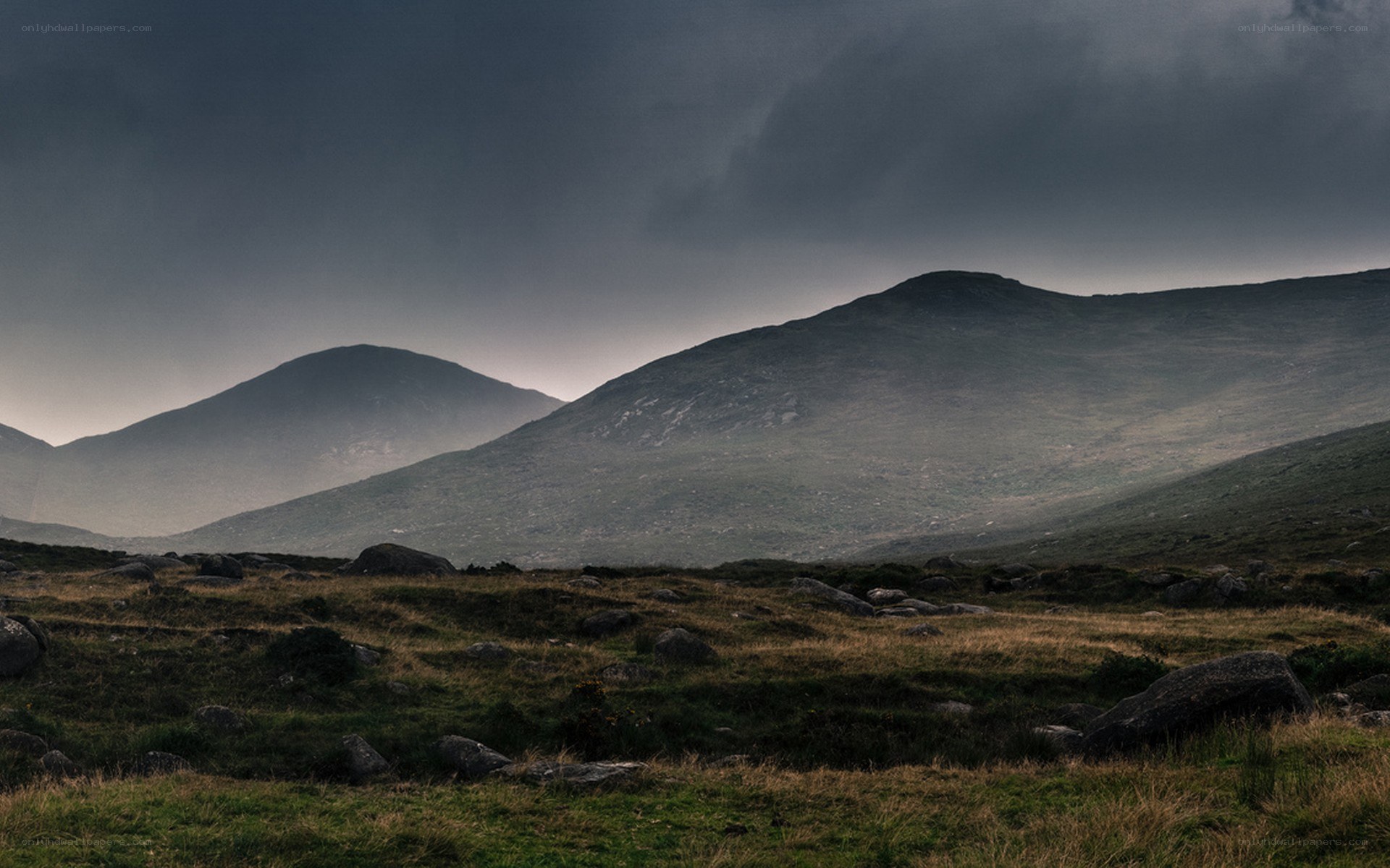 Dark mountains under stormy sky