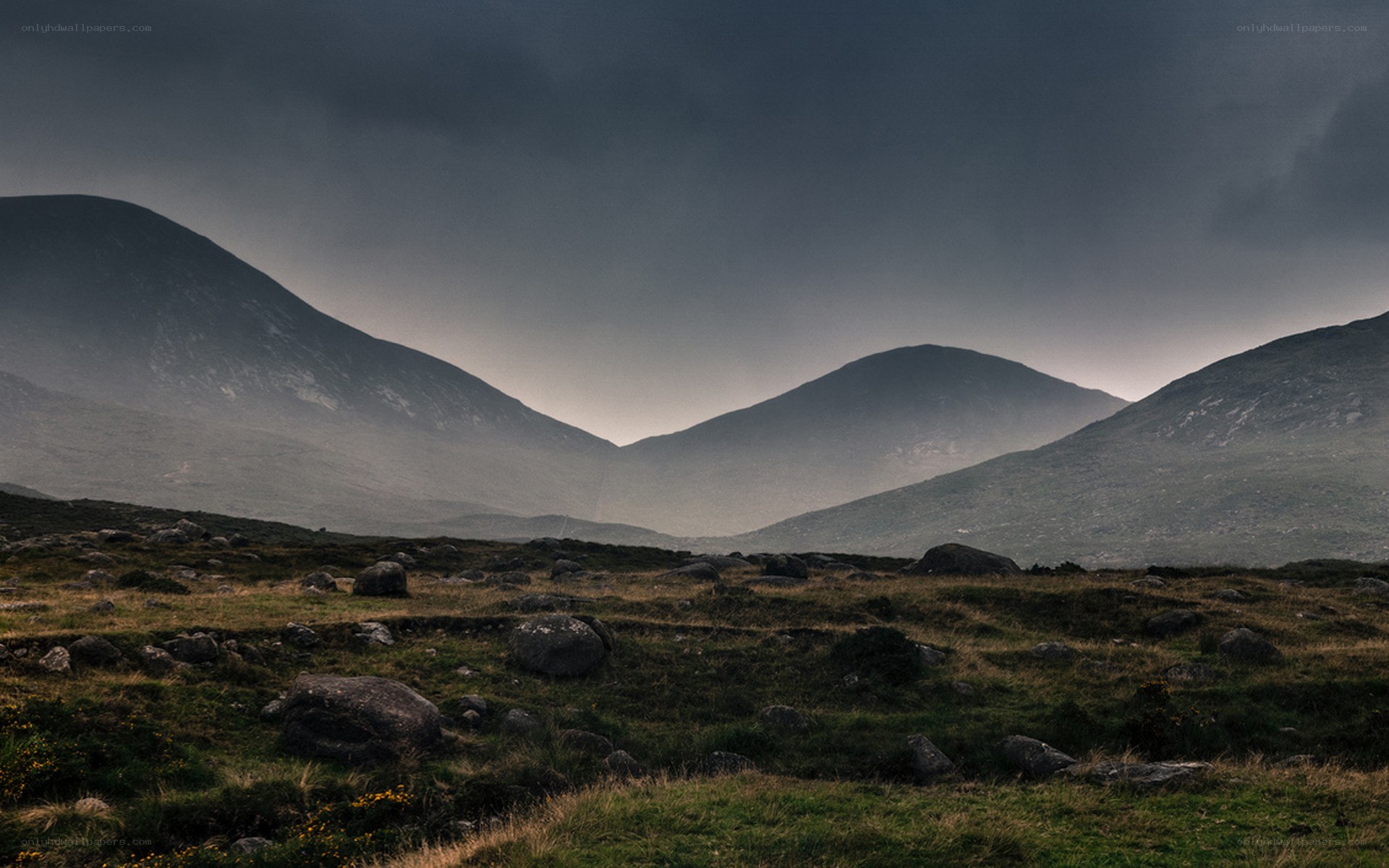Dark mountains under stormy sky