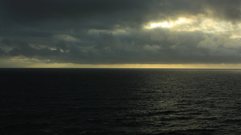 dark ocean under stormy sky