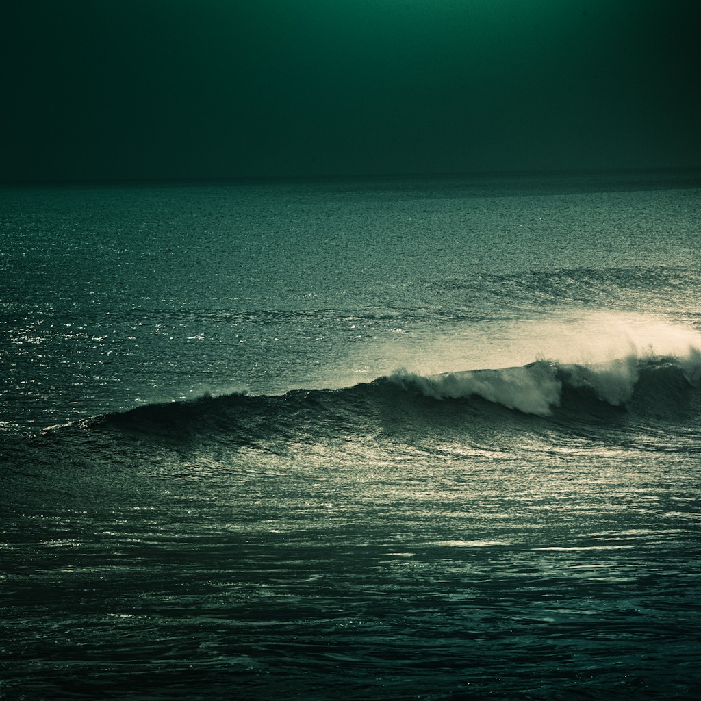 Dark ocean wave at dusk