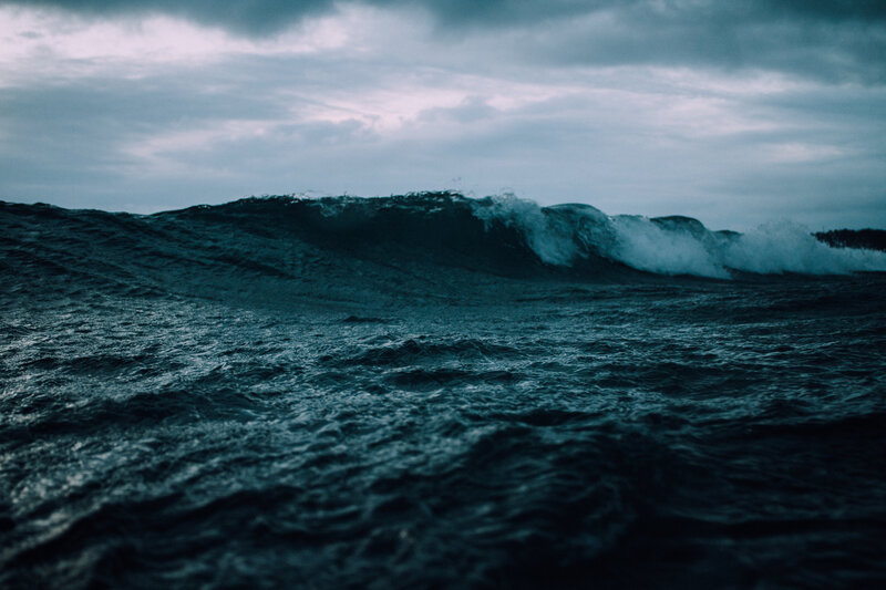 dark ocean wave at dusk
