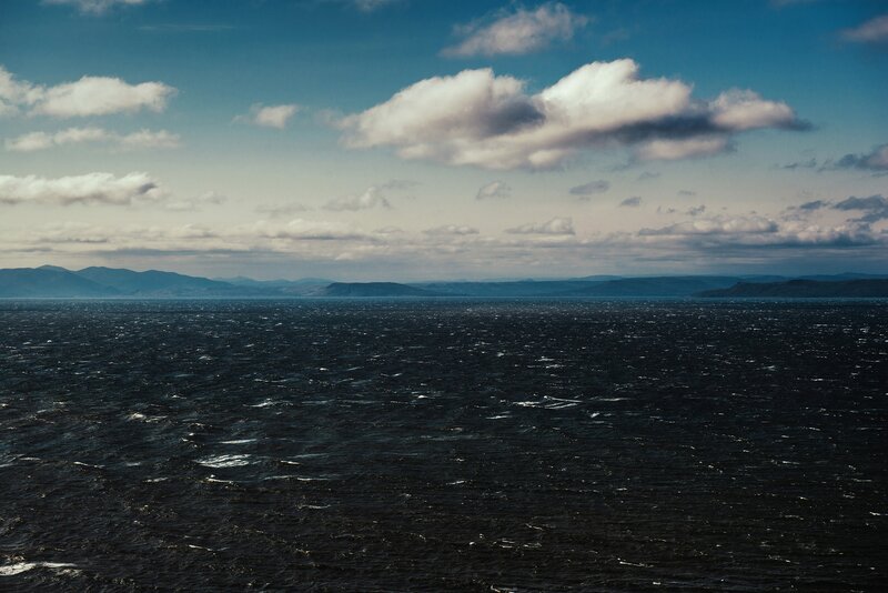 Dark Ocean with Distant Mountains
