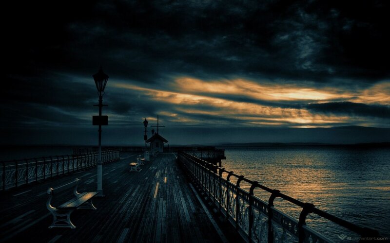 Dark pier at sunset