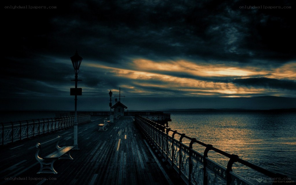 Dark pier at sunset