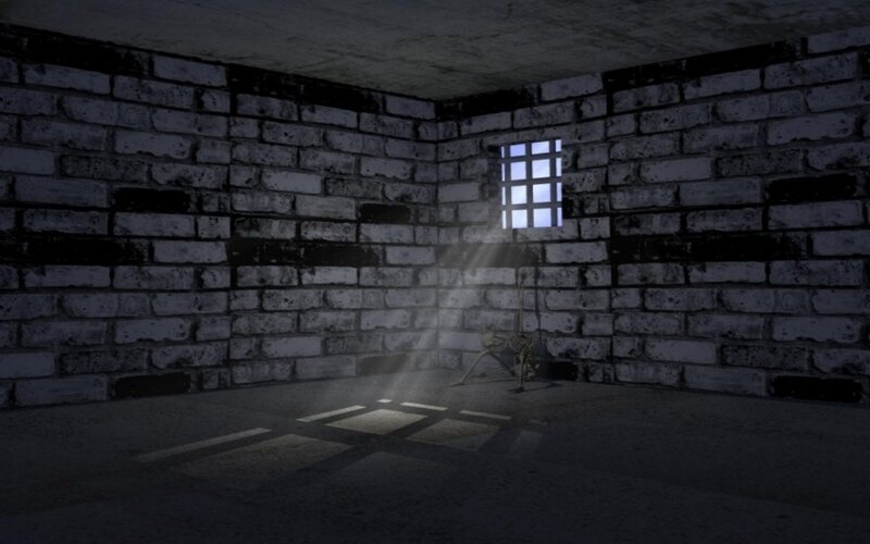 dark prison cell with skeleton