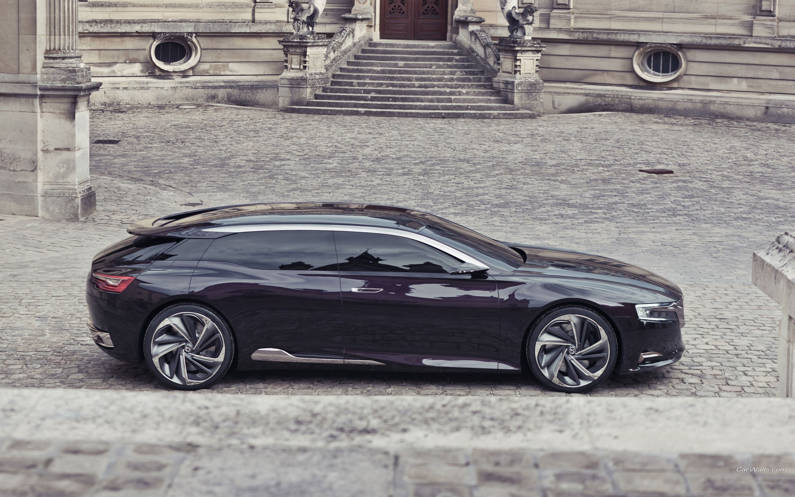 Dark purple concept car on cobblestones