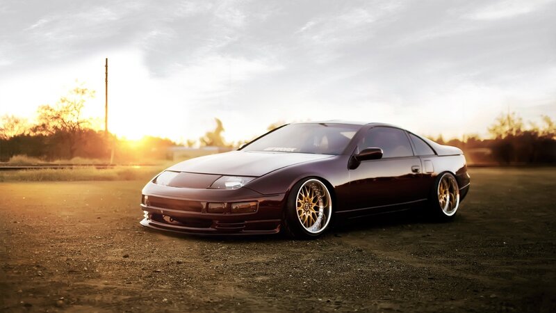 dark purple sports car at sunset
