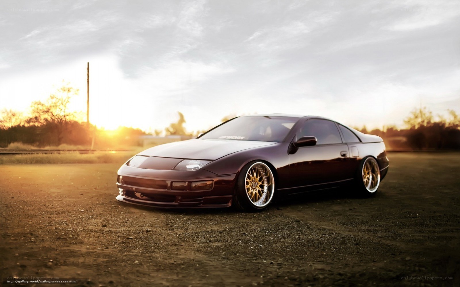 dark purple sports car at sunset