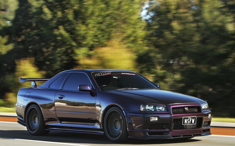 Dark purple sports car in motion