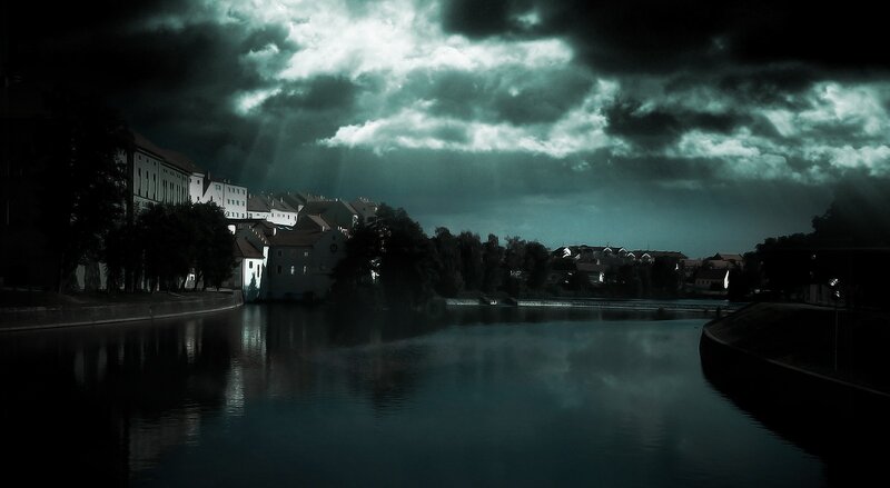 Dark river town at night