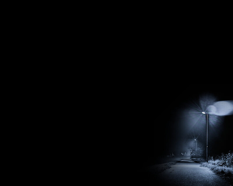Dark road at night with streetlights