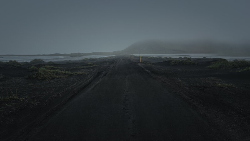 Dark Road in Volcanic Landscape