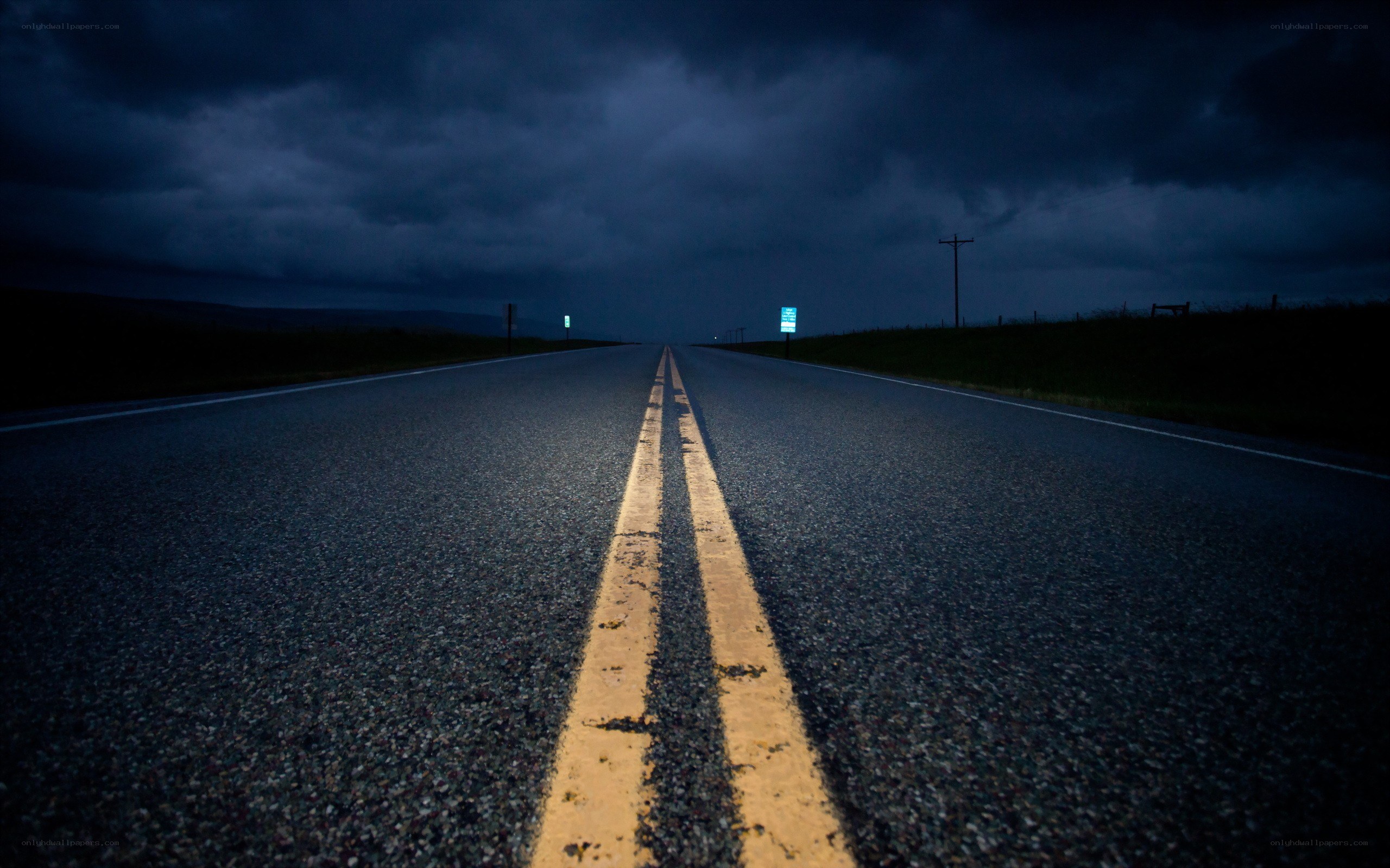 Dark road under stormy sky
