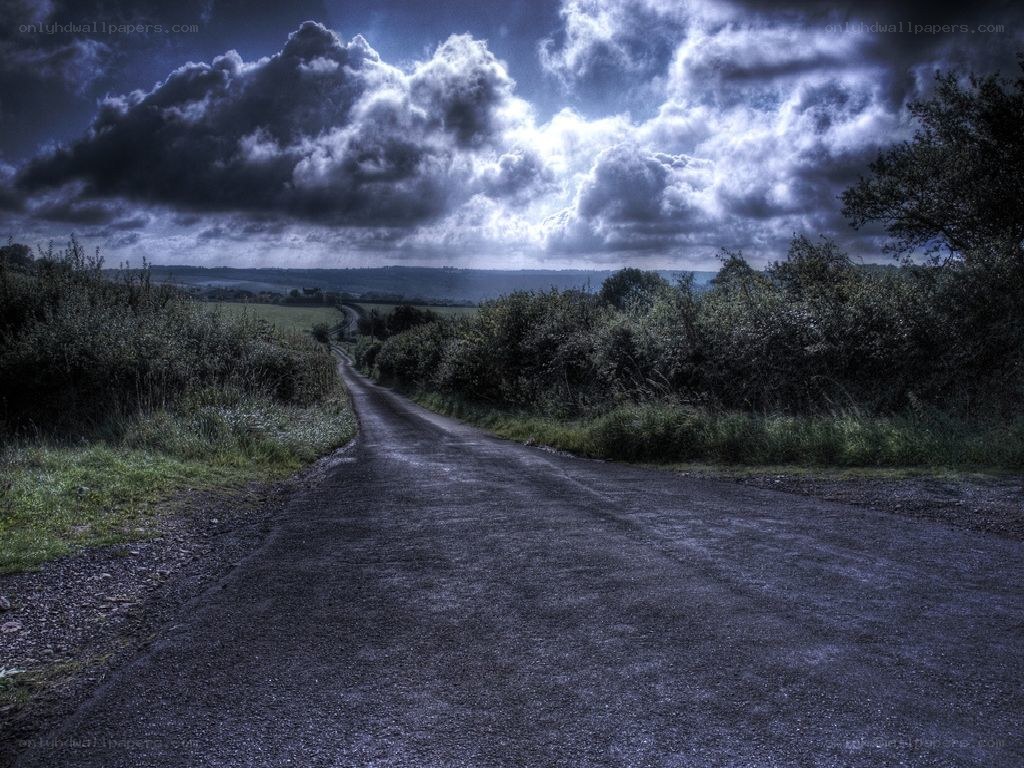 Dark road under stormy sky