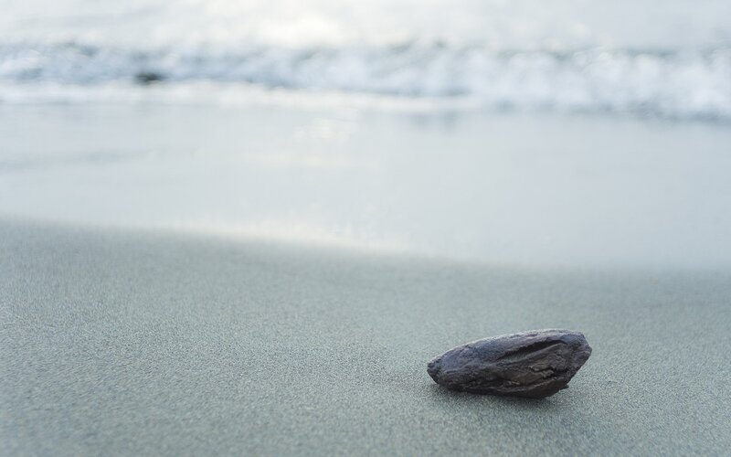 Dark Rock on Sand
