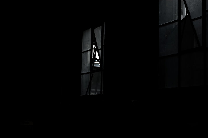 dark room with broken windows
