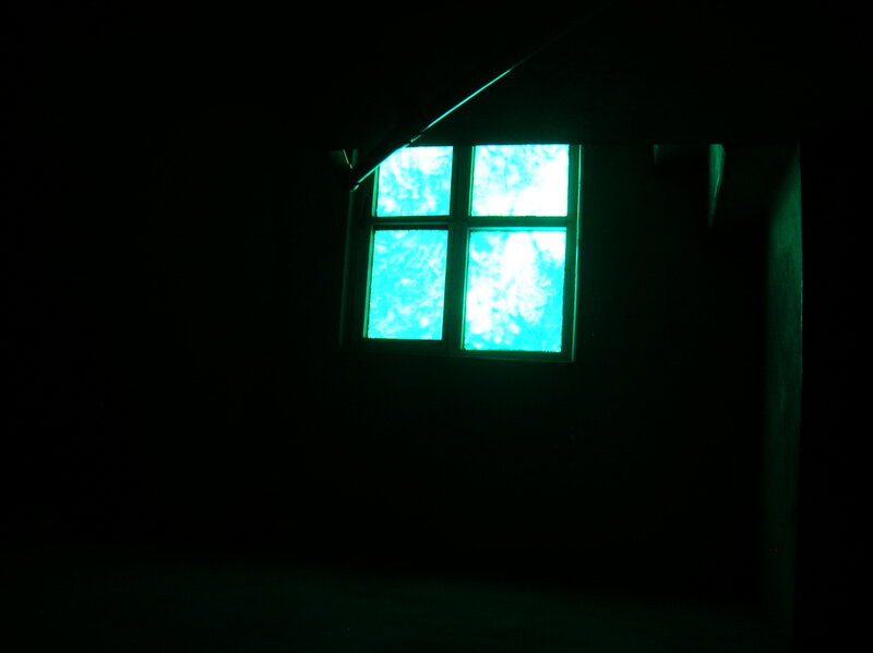 dark room with glowing window