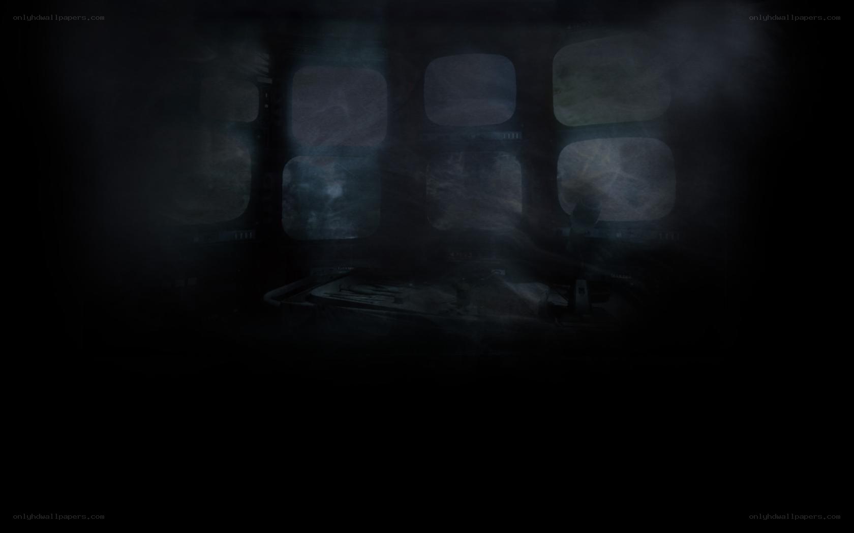 dark room with monitors