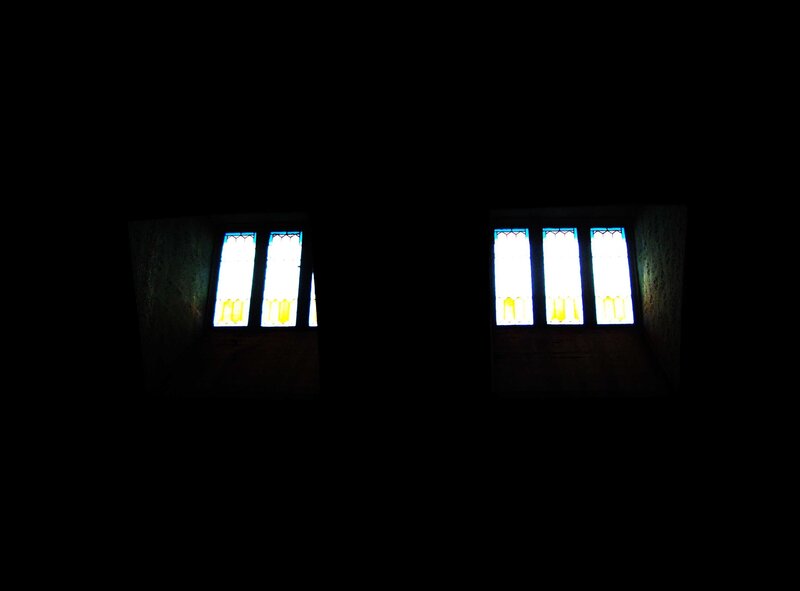 dark room with stained glass windows