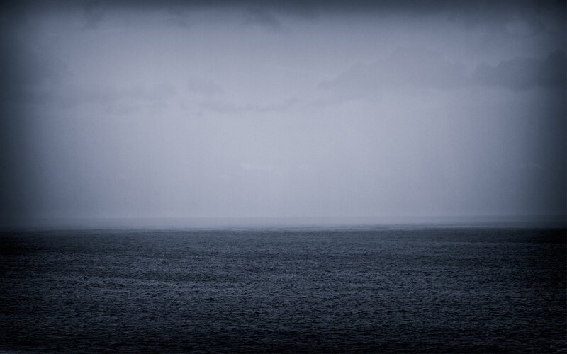 dark sea under stormy sky