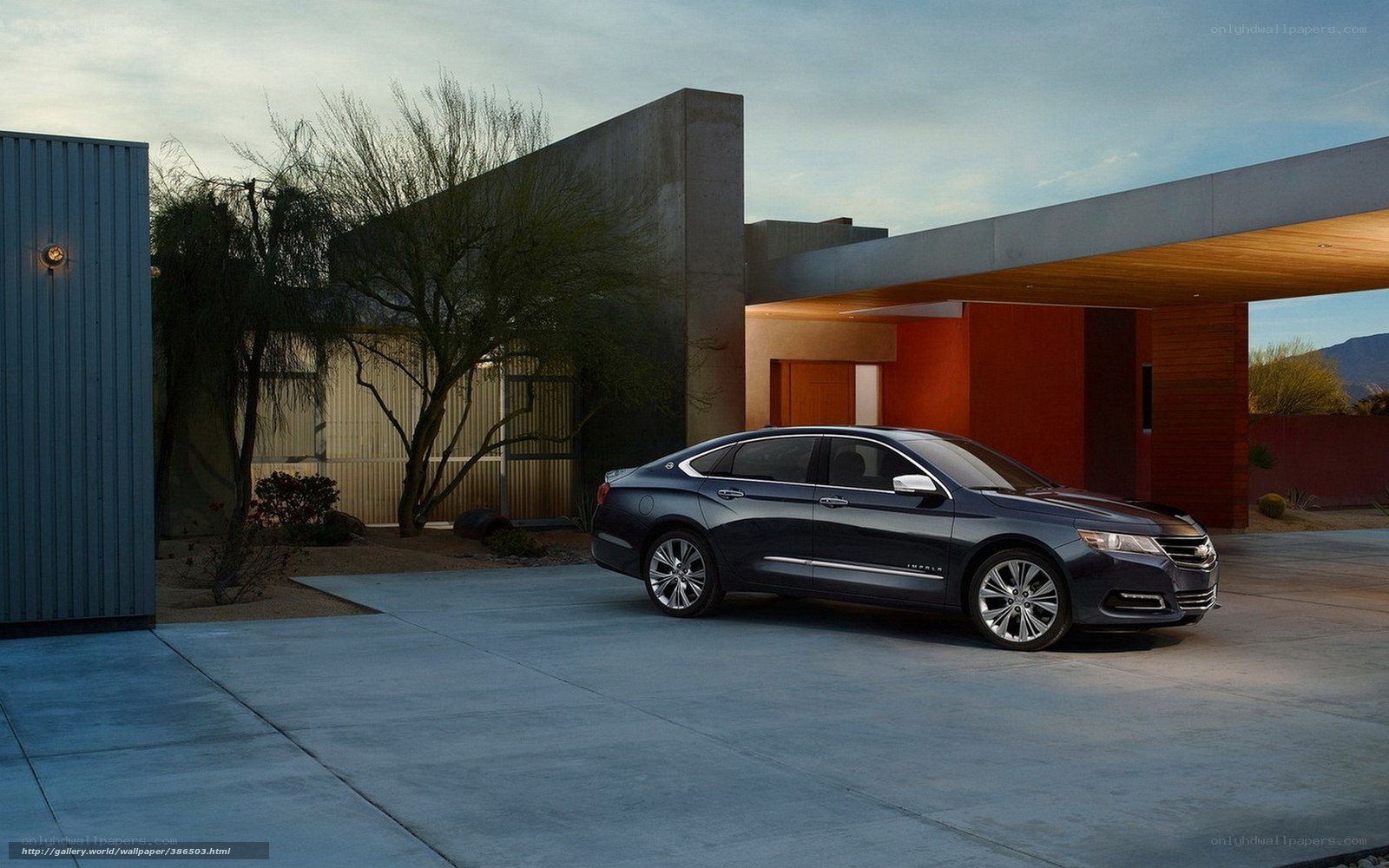 Dark sedan in modern driveway