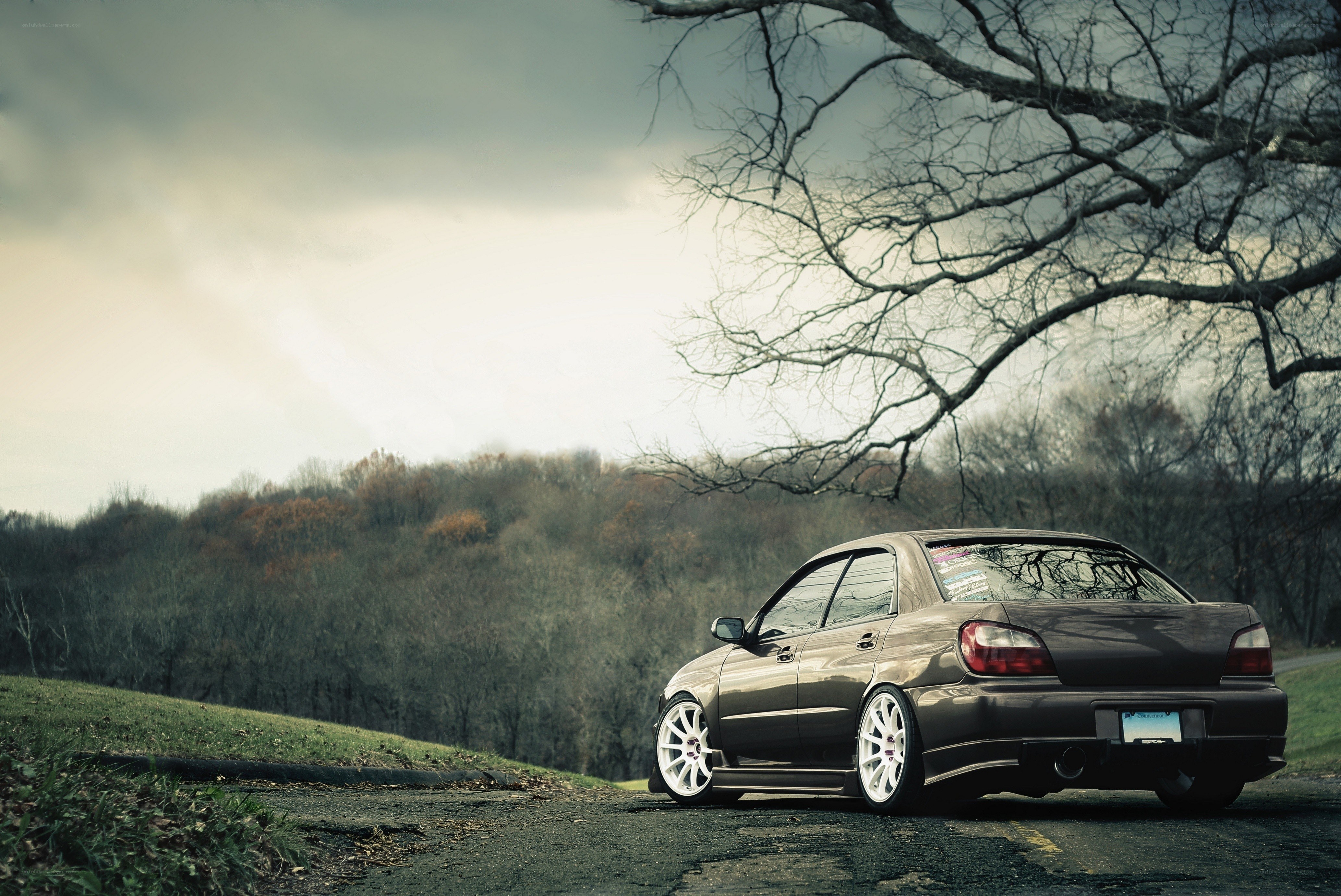 Dark sedan on a rural road
