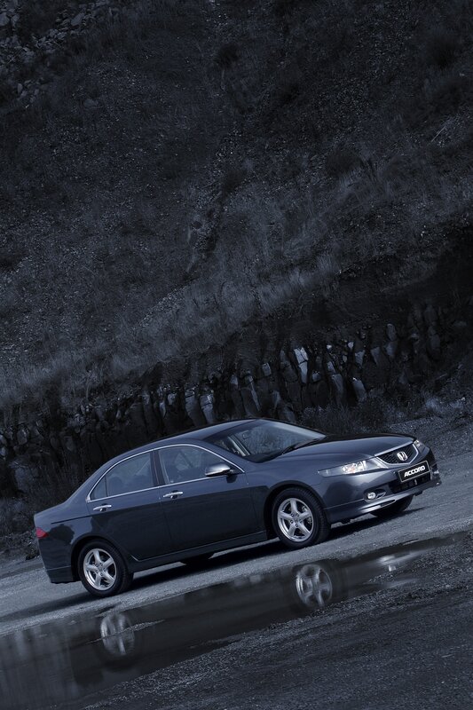 Dark sedan on wet road