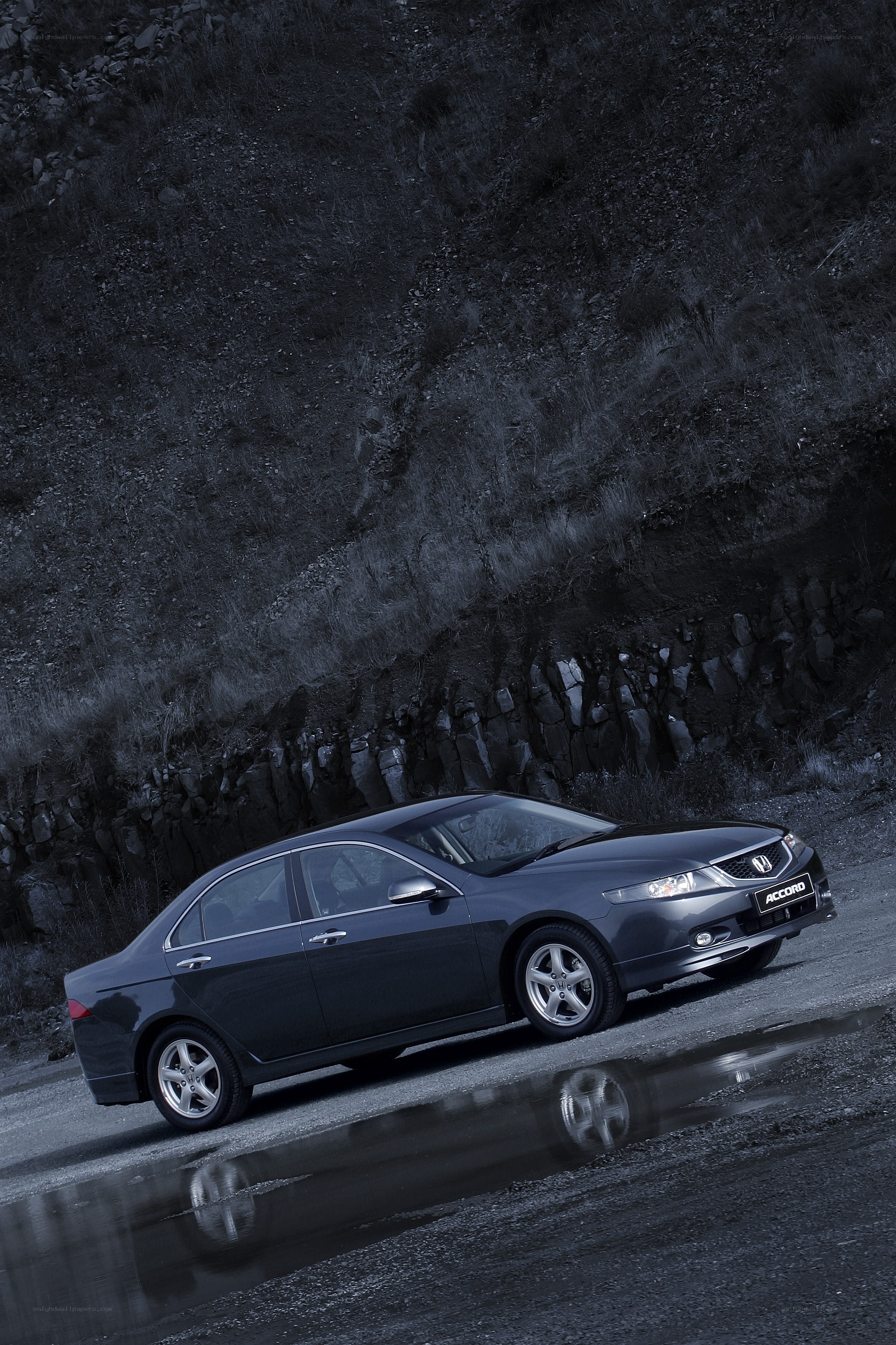 Dark sedan on wet road